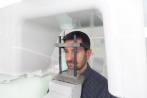 Dental patient inside CBCT machine, ready for scan